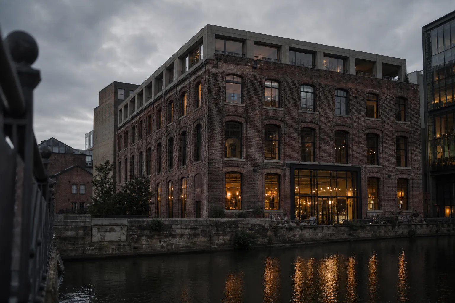 Calder House, a restored brick riverside warehouse on The Calls, Leeds, seen from the opposite bank